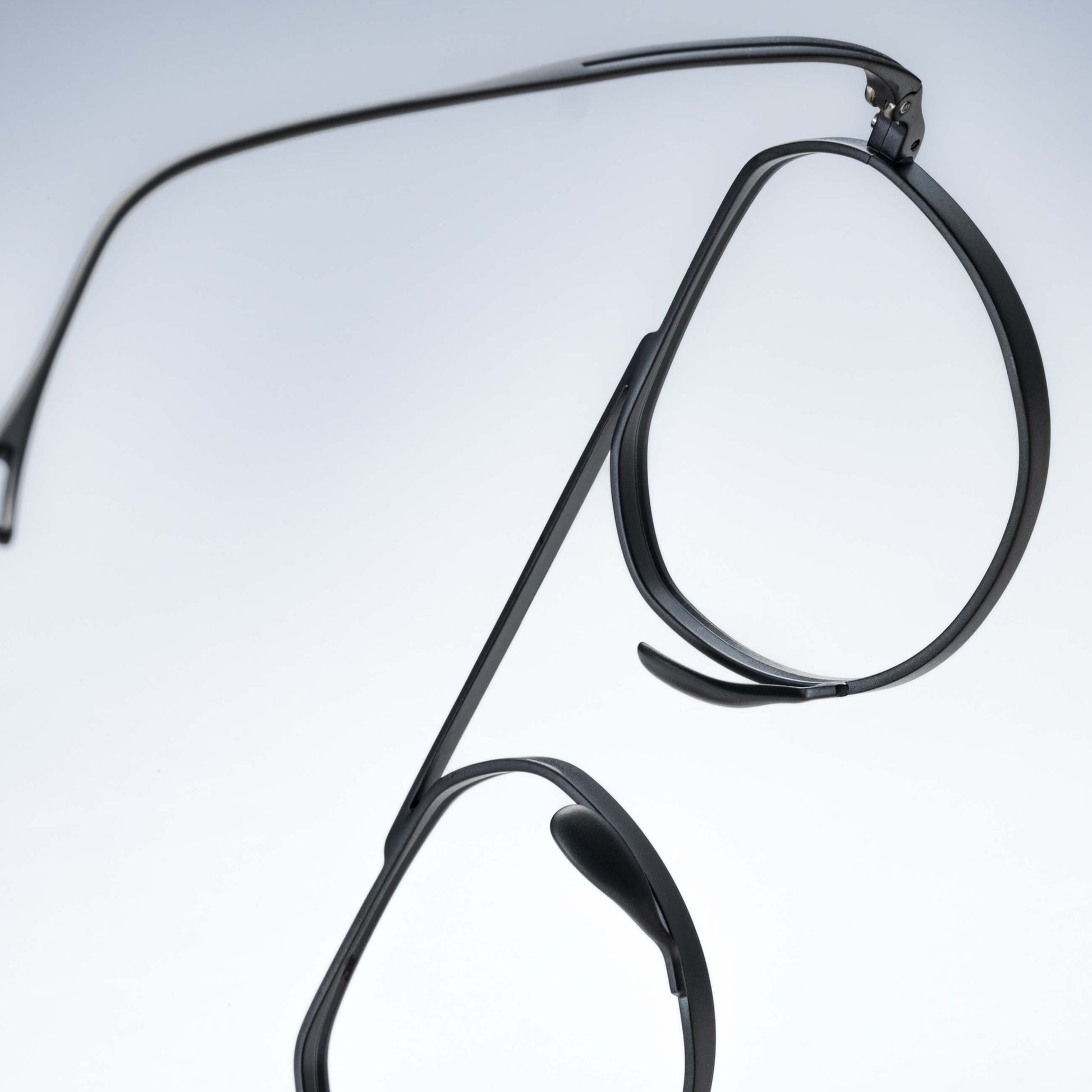 Black eyeglasses on a light gray background