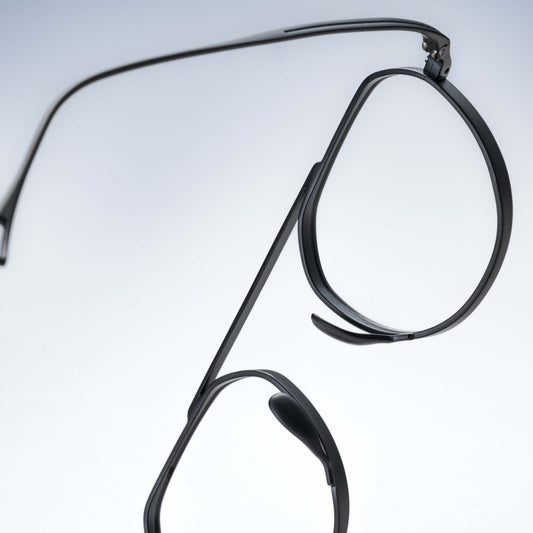 Black eyeglasses on a light gray background